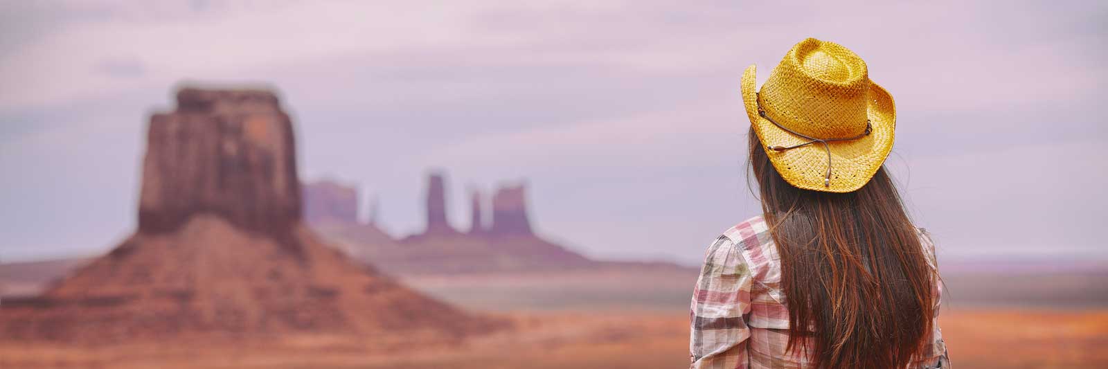 a woman looking out of a desert horizon